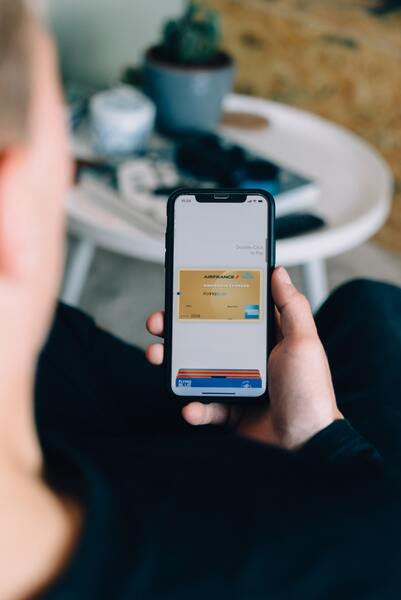 An iPhone being used in a contactless Apple Pay purchase.