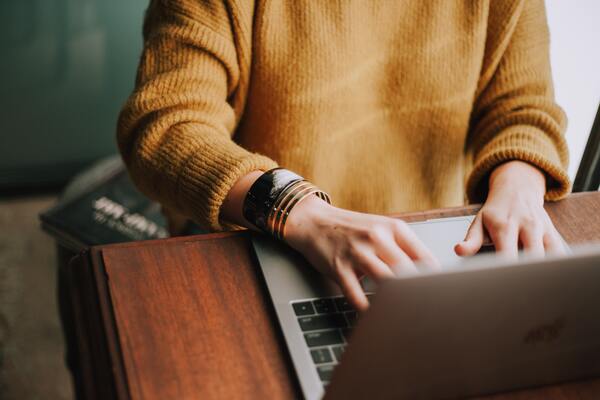 Woman typing into a computer